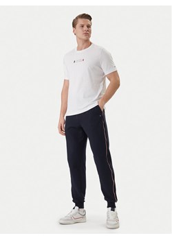 Tommy Hilfiger Spodnie dresowe Global Stripe MW0MW42882 Niebieski Regular Fit ze sklepu MODIVO w kategorii Spodnie męskie - zdjęcie 188835877
