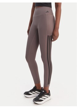 adidas Legginsy Optime Workout 3-Stripes KE7530 Szary Slim Fit ze sklepu MODIVO w kategorii Spodnie damskie - zdjęcie 188868917