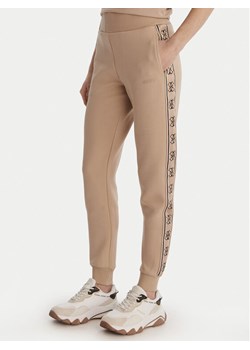 Guess Spodnie dresowe V2YB15 KB3P2 Beżowy Regular Fit ze sklepu MODIVO w kategorii Spodnie damskie - zdjęcie 188935168