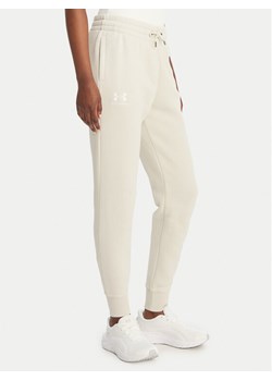 Under Armour Spodnie dresowe UA Icon Fleece 6001537 Beżowy Slim Fit ze sklepu MODIVO w kategorii Spodnie damskie - zdjęcie 189187847